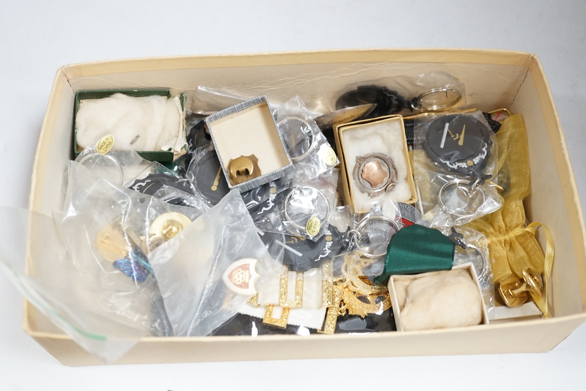 A collection of objects to include a triangular Masonic silver pocket watch, assorted Masonic fobs, enamel buckles, silver presentation spoons and sundries. Condition - varies, mostly fair